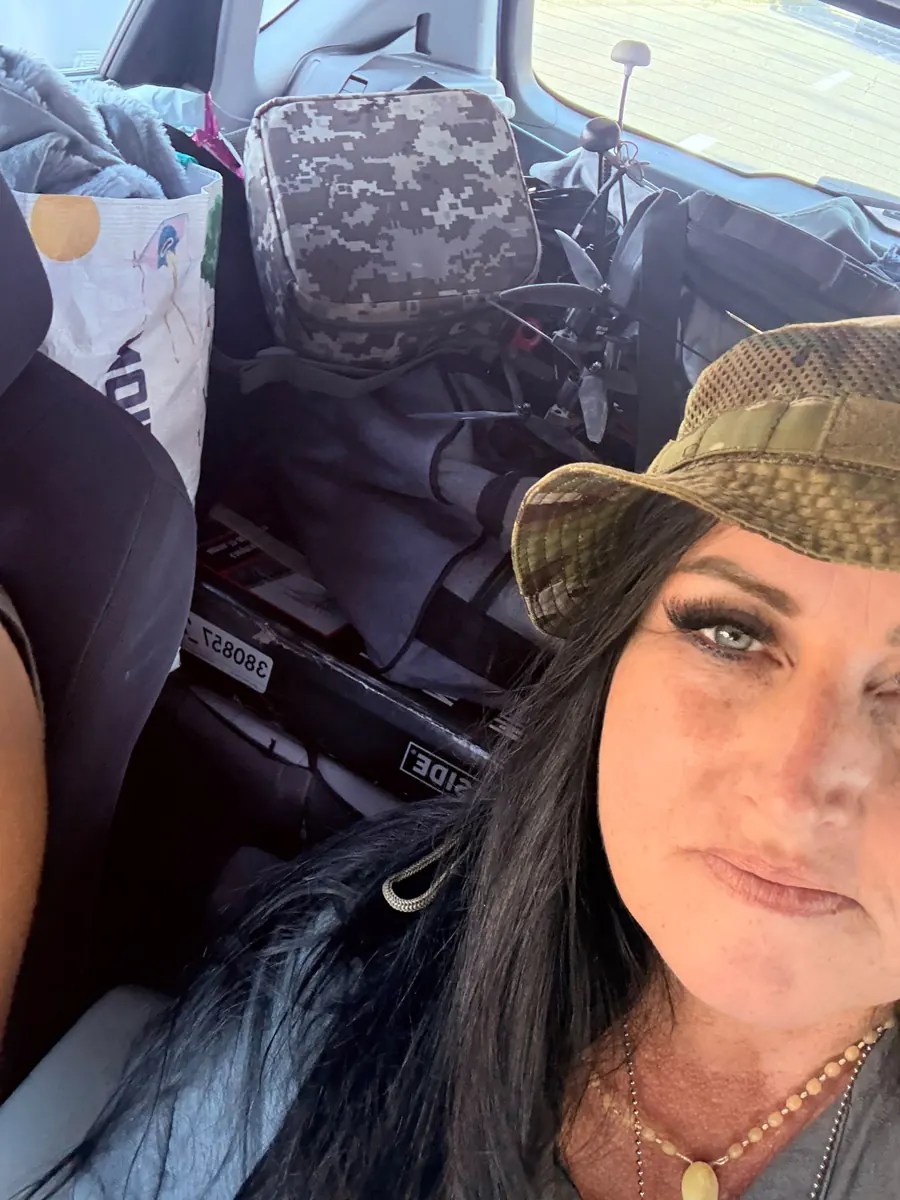 Maruška in a car loaded with supplies